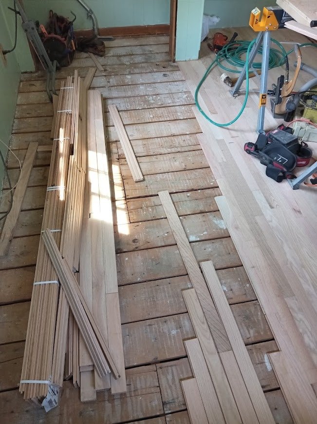 Completed hardwood floor installation with clean board layout